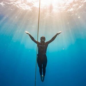 A freediver ascending along the line during a freedive course in Australia