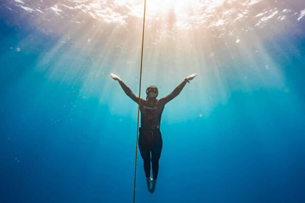 A freediver ascending along the line during a freedive course in Australia